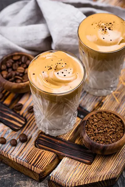 Iced coffee in glasses on wooden table
