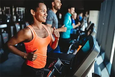 Woman Working Out in Fitness Center at Six Cord Apartments