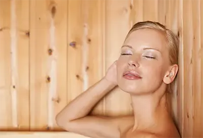 Woman relaxing in Sauna