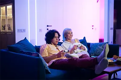 A couple watching a movie in the TV lounge at Six Cord Apartments