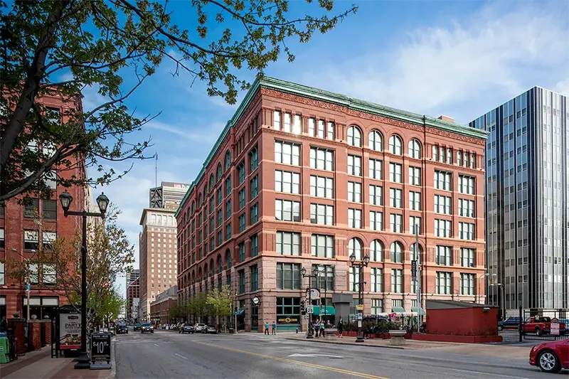Streetlife exterior of renovated historic loft-style apartment building on Washington Avenue in Downtown St. Louis, MO